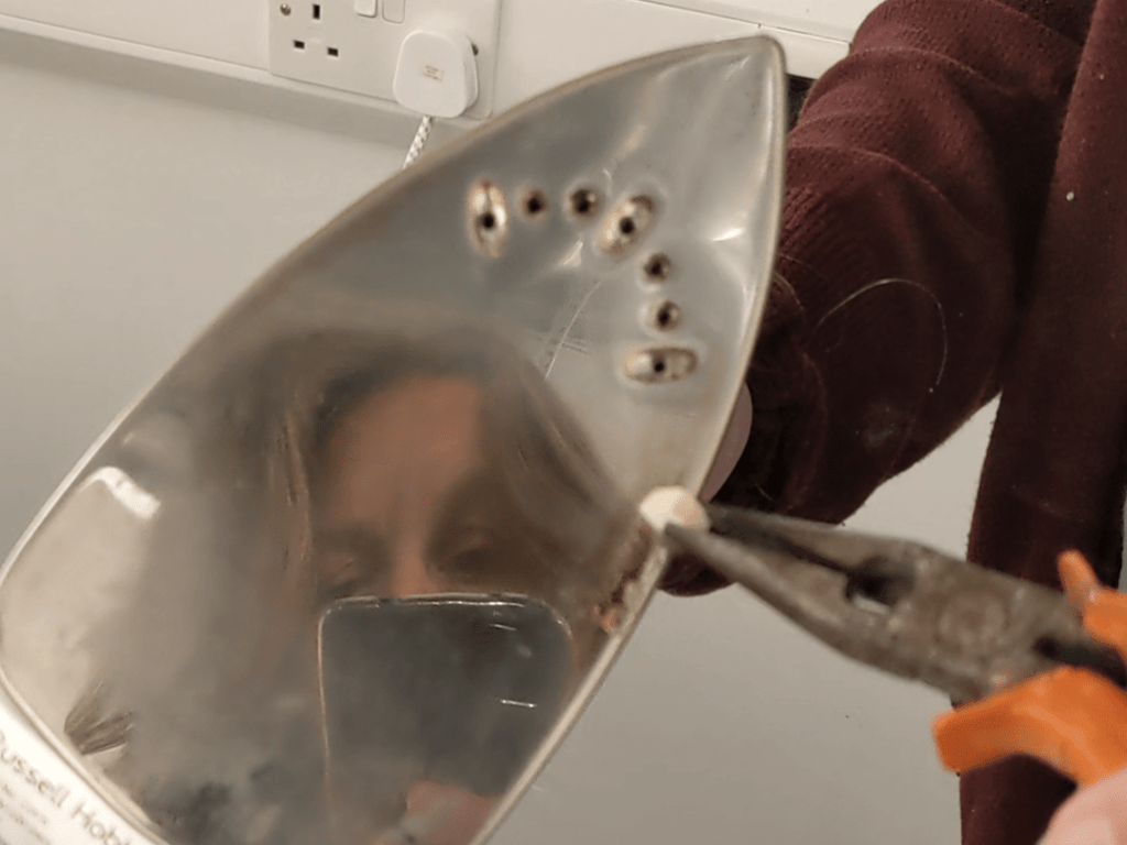 Iron being rubbed with paracetamol on the marks.