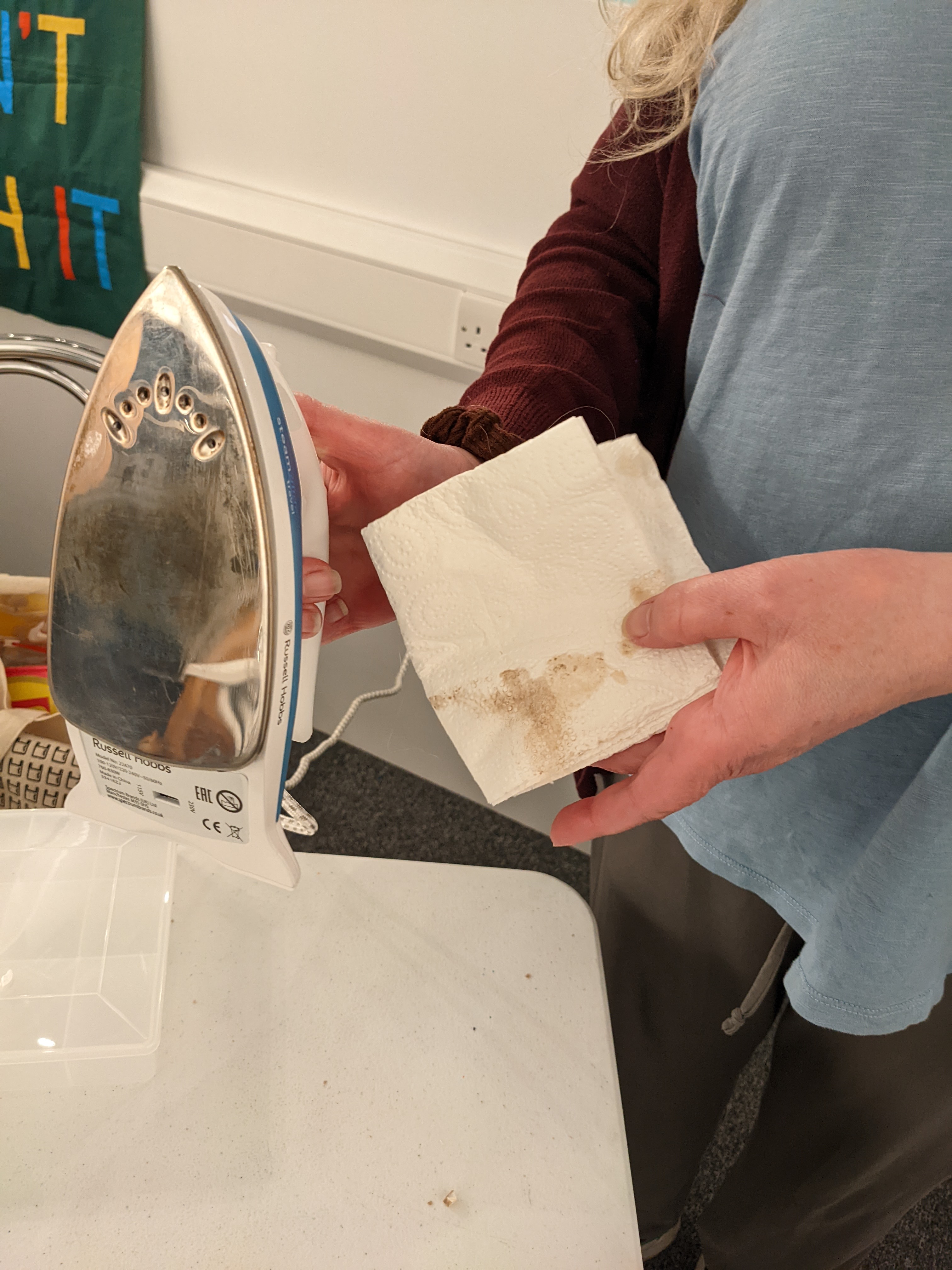 Shiny Iron with dirty kitchen towel showing how much has been removed. 