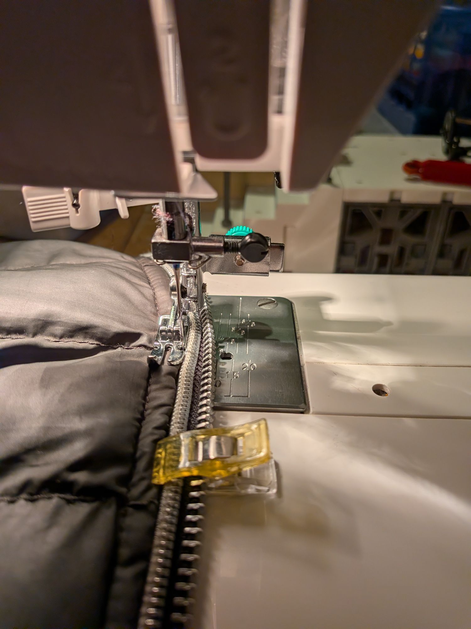 Using a sewing machine to sew the zip in place